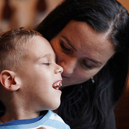 a mother and a smiling young child